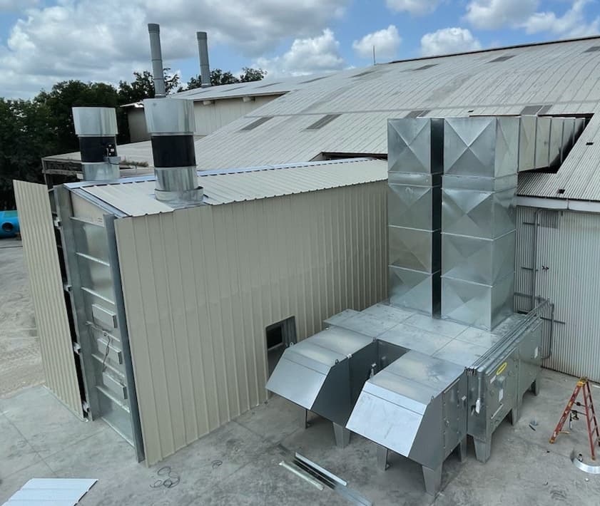 An outdoor spray booth seen from above on its concrete pad