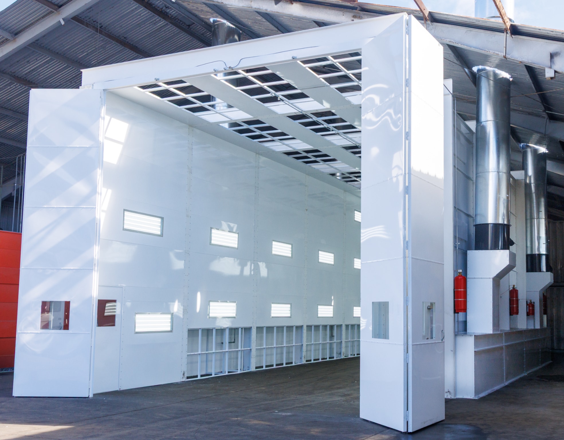 A large drive-in spray booth built by California Pulse, doors open
