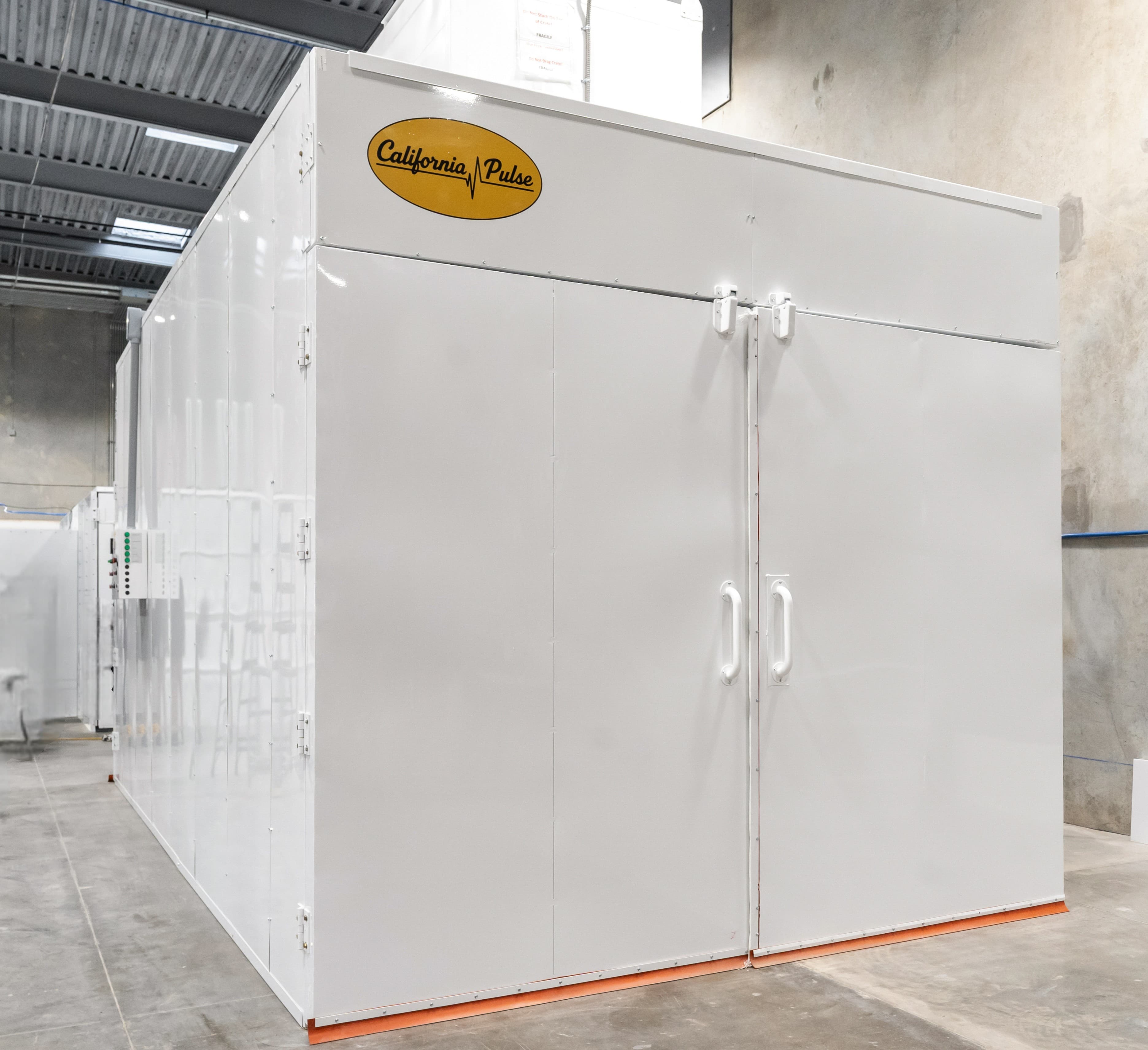 A cure oven with its doors open