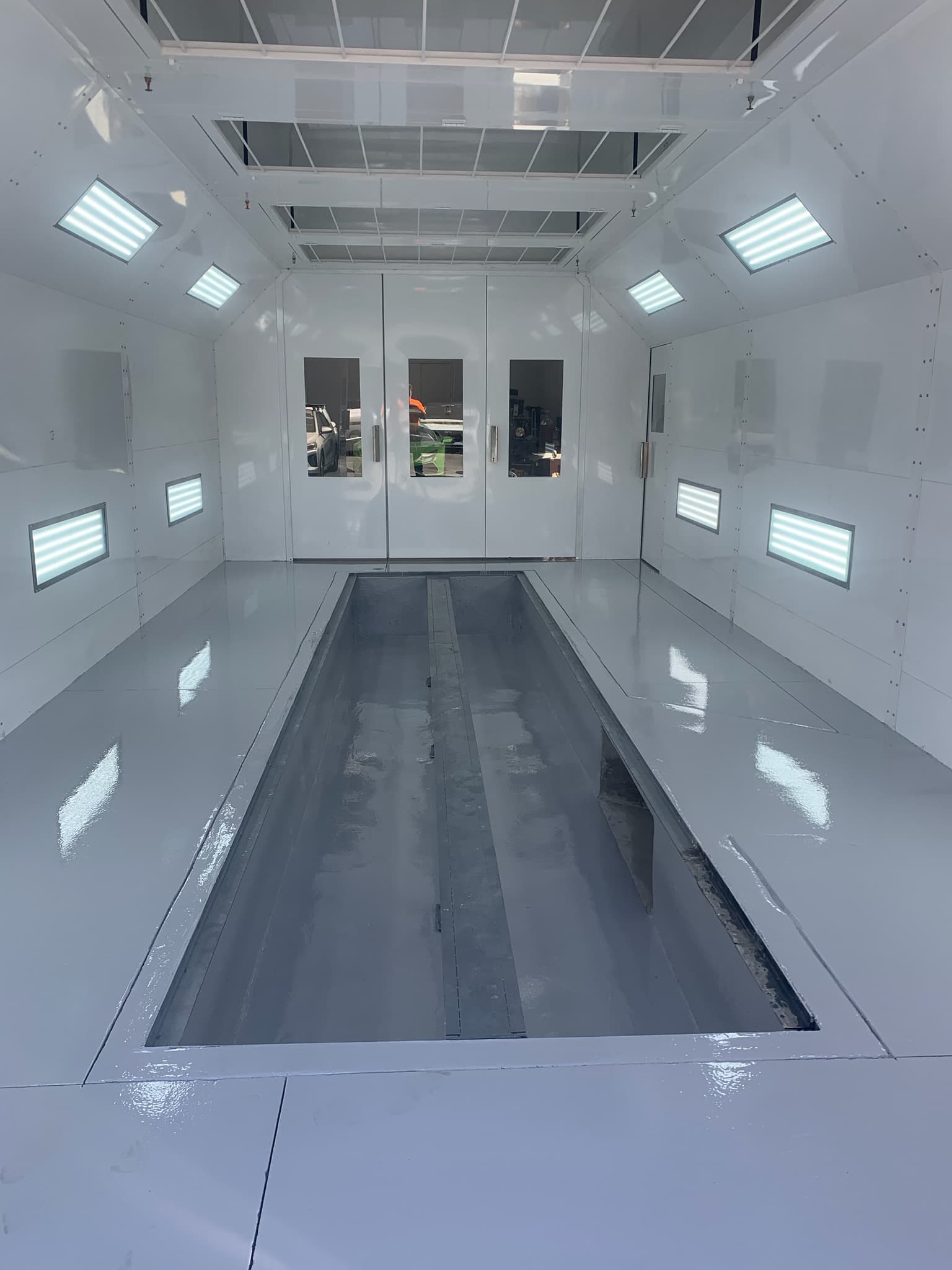 A spray booth floor pit and grating during construction