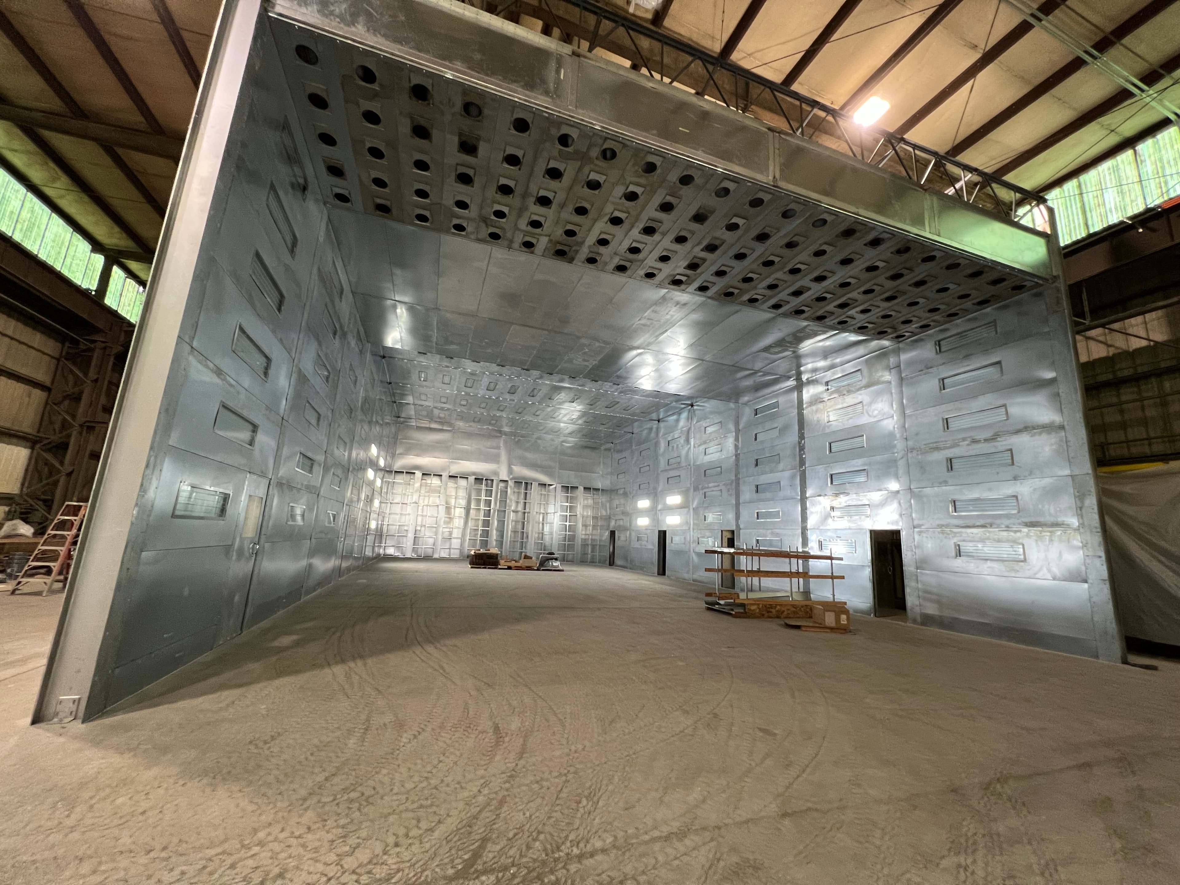 An open face spray booth in a workshop