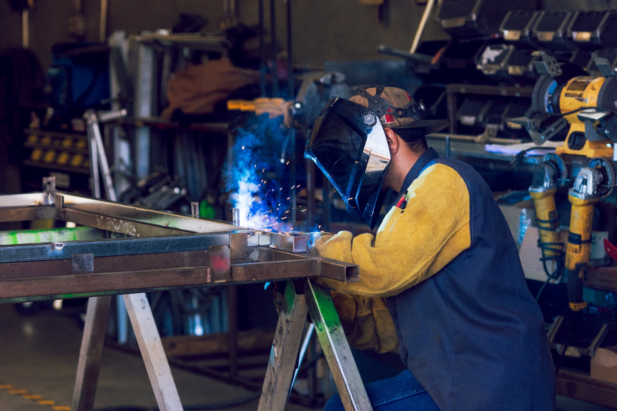 A California Pulse technician welding steel in the Apple Valley fabrication shop