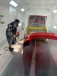 Full Downdraft spray booth for automotive painting in action.