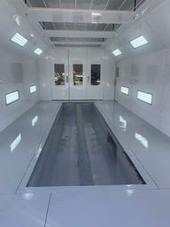 Interior view of a full down draft paint booth with LED lighting.