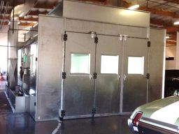 Side down draft spray booth with side exhaust filter system.